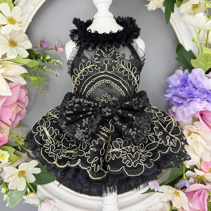 Black lace dress on a mannequin surrounded by flowers