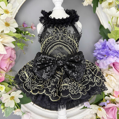 Black lace dress on a mannequin surrounded by flowers