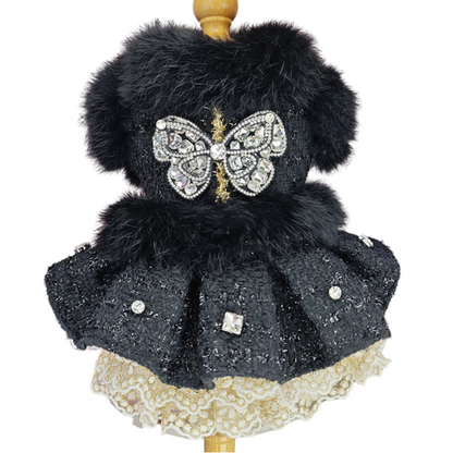 Decorative item with black fur, butterfly design, and lace skirt on a white background