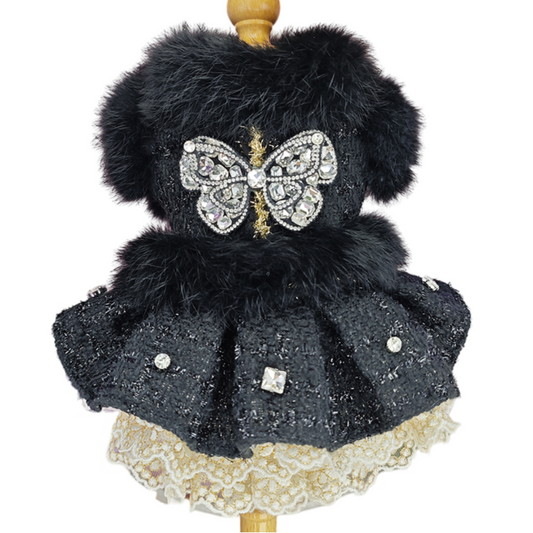 Decorative item with black fur, butterfly design, and lace skirt on a white background