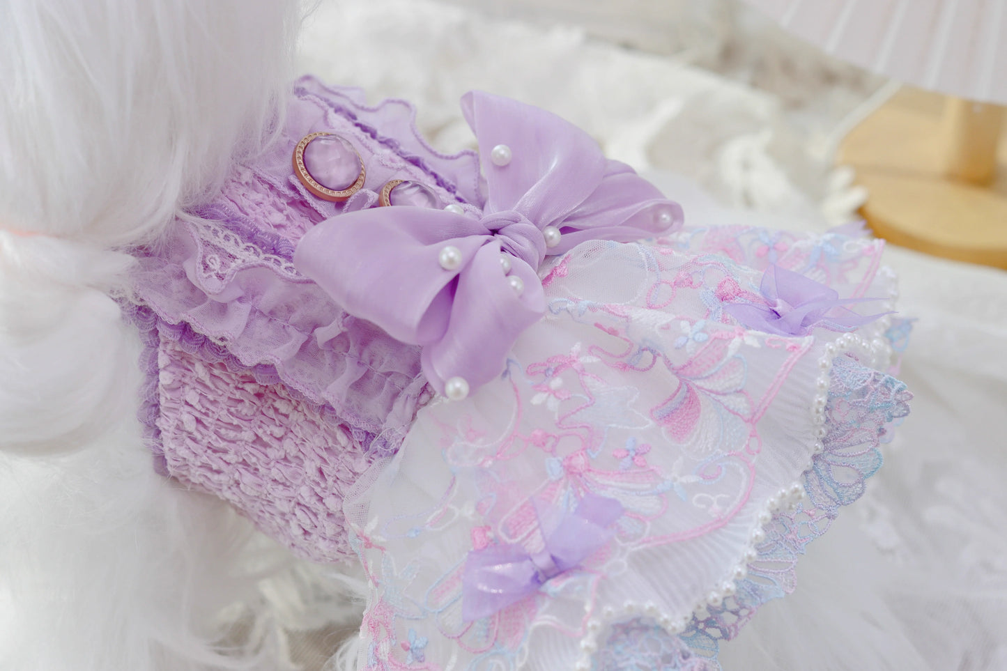 Lavender lace pet dress with decorative elements on a white background