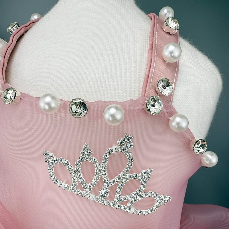 Pink apron with pearl and crystal decorations on a mannequin