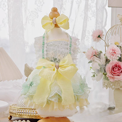 Decorative mannequin with a yellow bow and lace dress in a soft, blurred indoor setting.