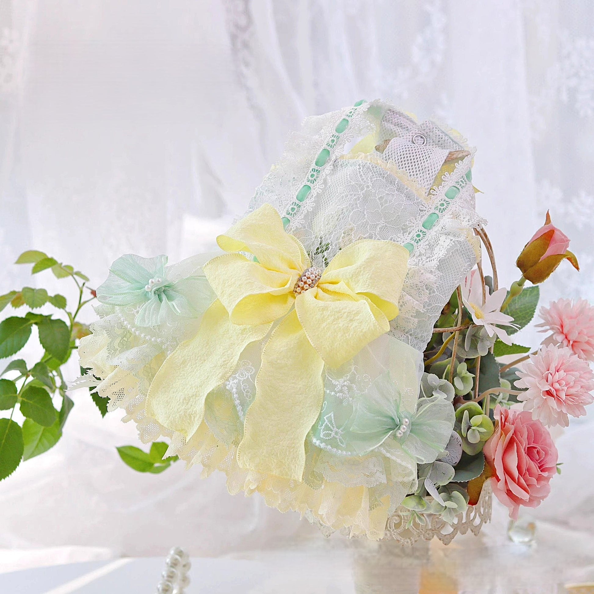 Pastel-colored headband with flowers and greenery on a white background