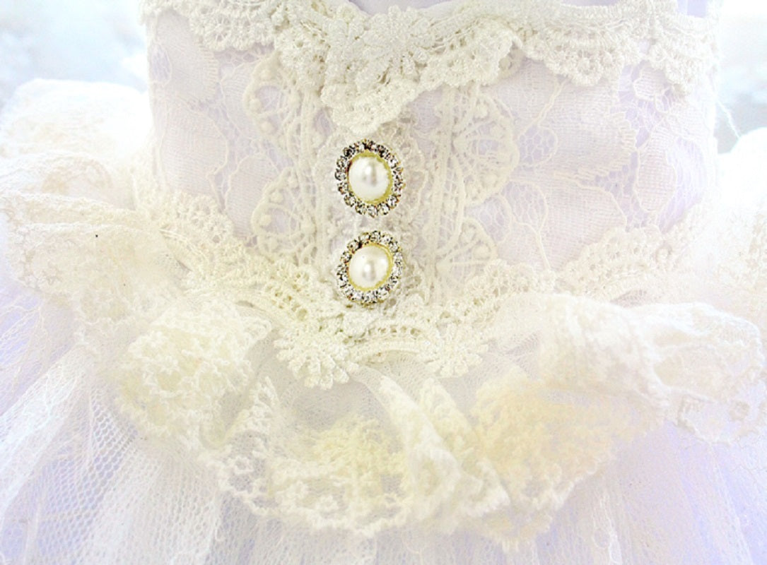 Pearl earrings on a white lace background