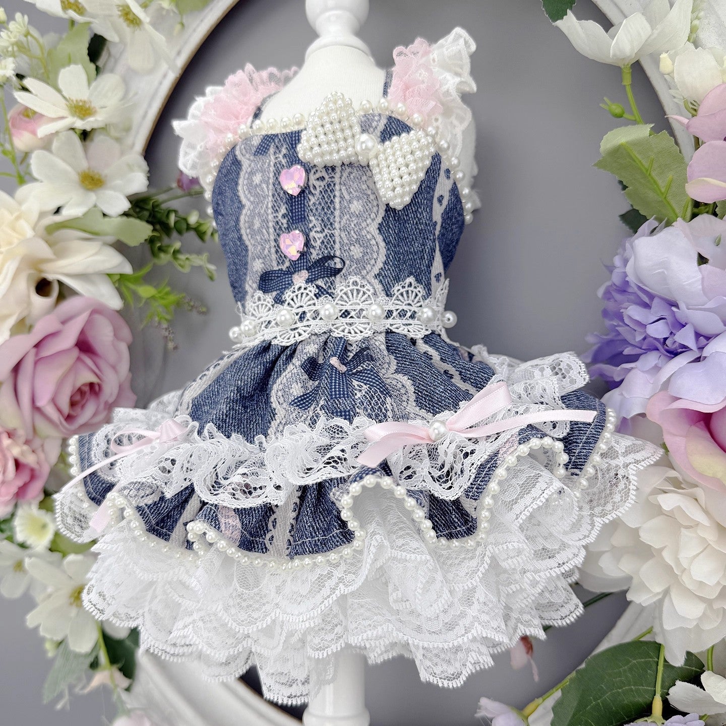 Lace dress on a mannequin surrounded by flowers
