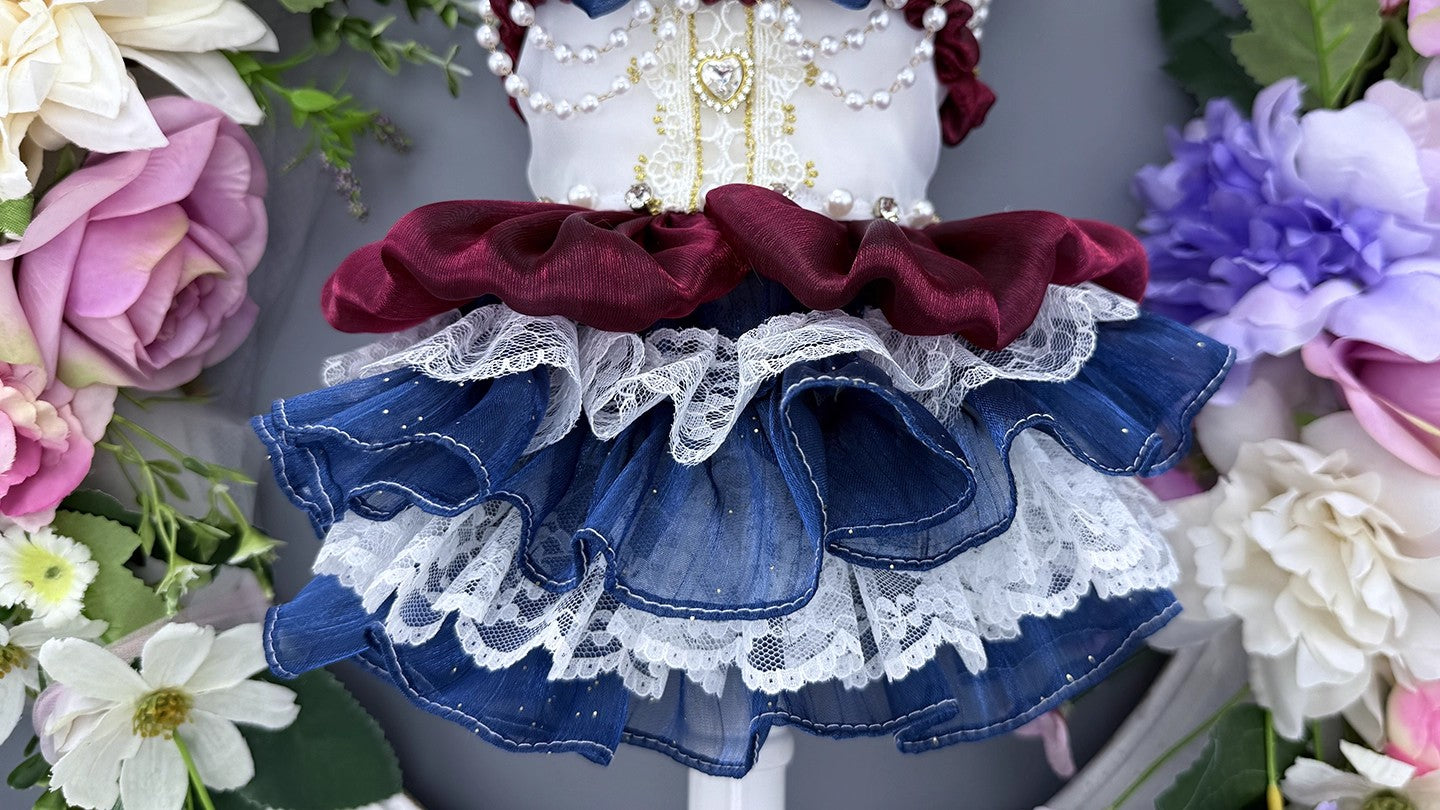 Doll wearing a dress with red, white, and blue colors surrounded by flowers.