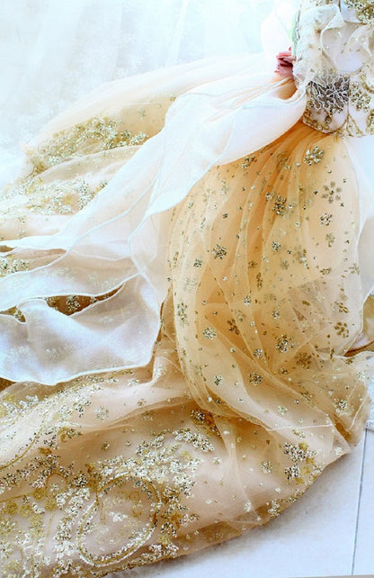 Delicate beige fabric with gold sequins on a white background