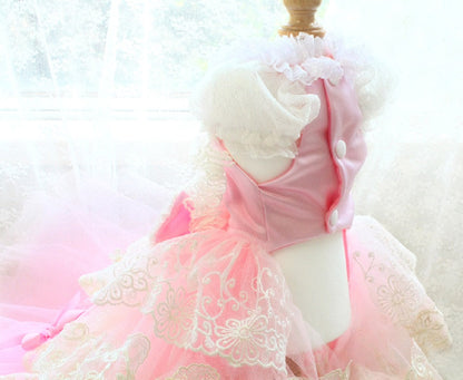 Pink dress with white lace details on a blurred background