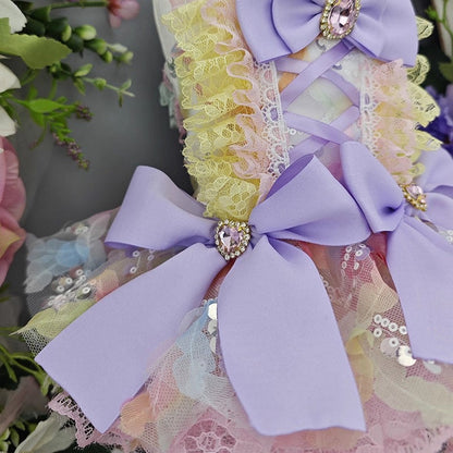 Decorative headband with purple bows and floral elements on a blurred floral background