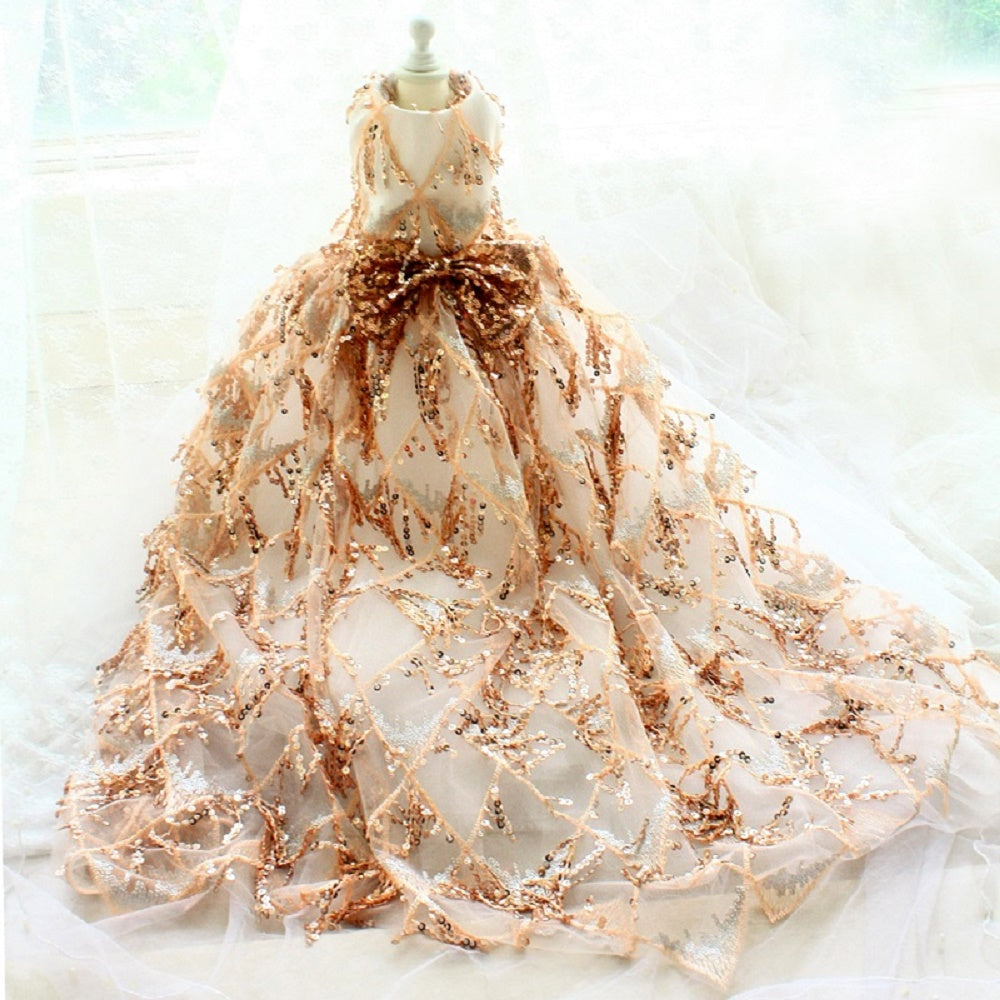 Elegant dress with gold embellishments on a mannequin against a light background