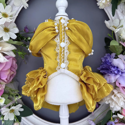 Yellow dress on a mannequin with floral decorations in the background
