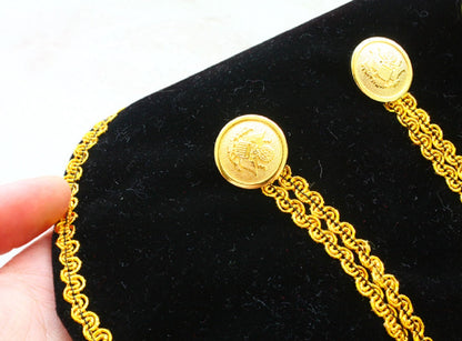 Gold chain with decorative buttons on a black background