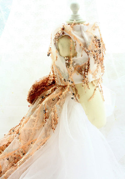 Mannequin wearing a beige and brown patterned scarf with a blurred background