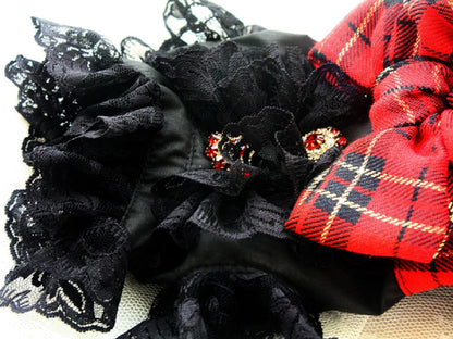 Black lace headband with red plaid fabric on a white background