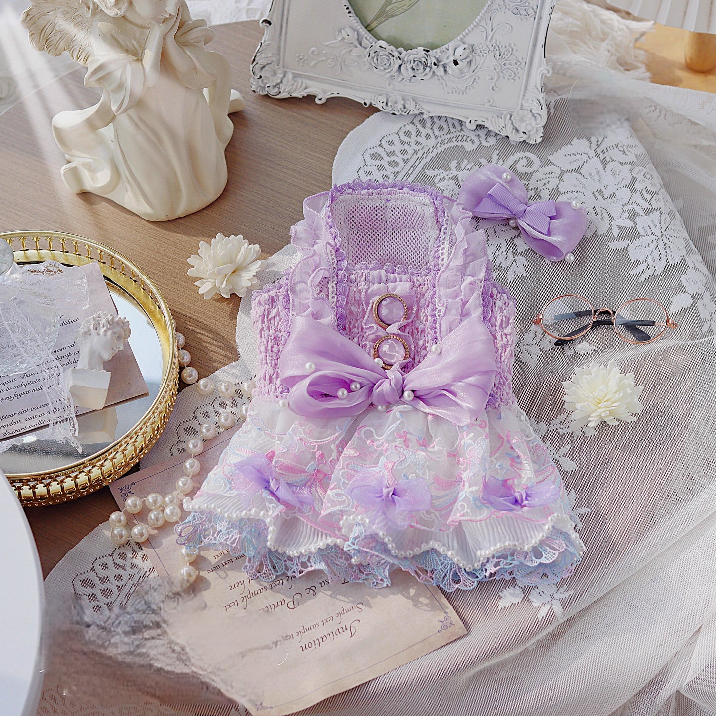 Decorative purple and white item with lace on a table with decorative items.