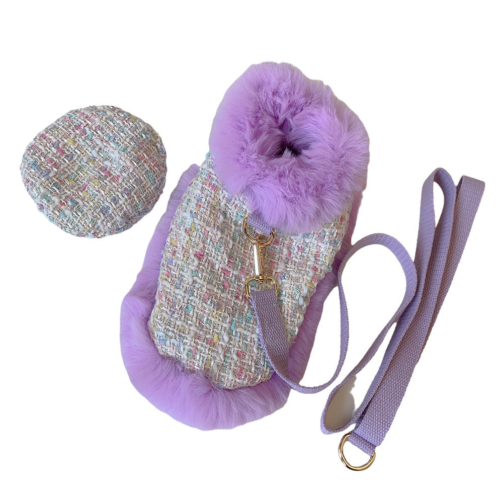 Purple pet carrier with fluffy pom-pom and matching round mat on a white background