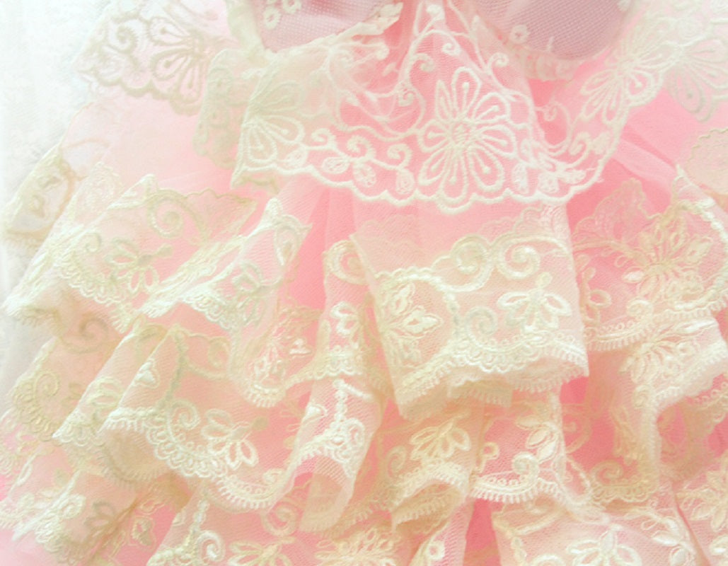 Close-up of pink lace fabric with intricate patterns