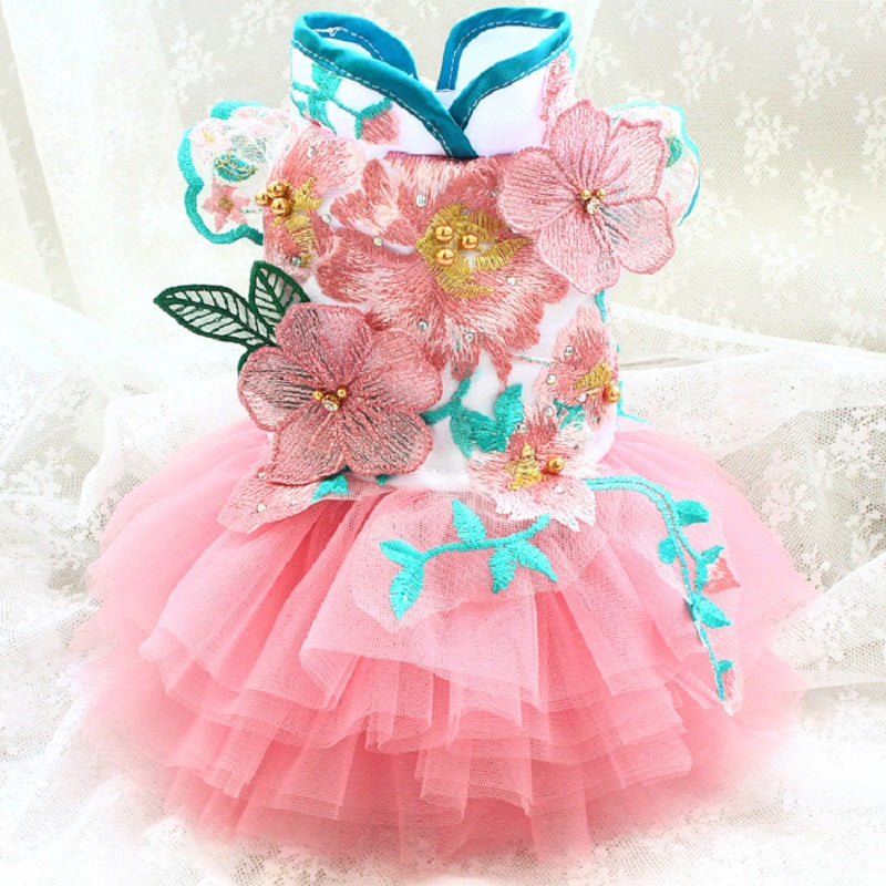 Pink floral dress with turquoise accents on a white background