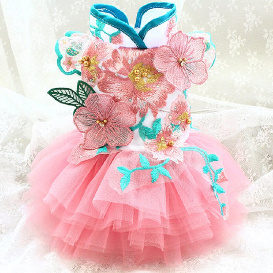 Pink floral dress with turquoise accents on a white background