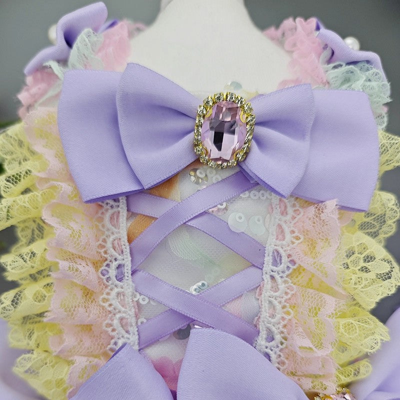 Decorative headband with a large purple bow and gemstone on a mannequin head.