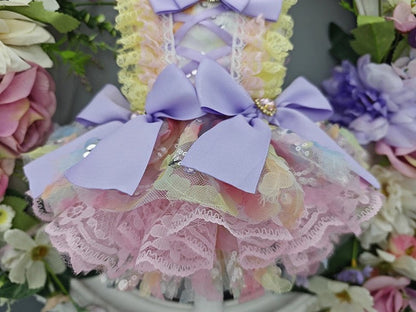 Decorative item with pastel colors and bows surrounded by flowers