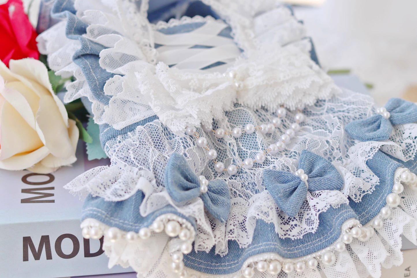 Close-up of a decorative headband with lace and pearls on a magazine background