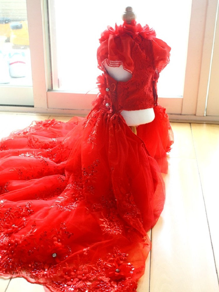 Red wedding dress on a mannequin against a windowed wall.