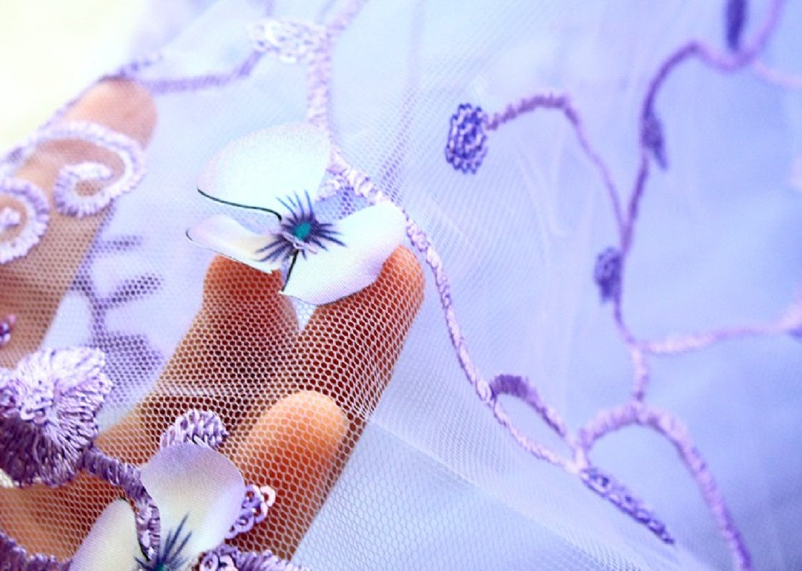 Close-up of a decorative headband with floral elements on a light purple background