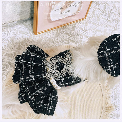 Black and white textured bow on a textured surface with a blurred background