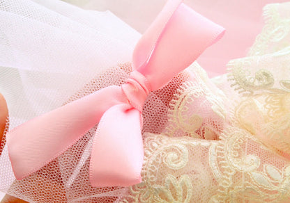 Close-up of a pink bow on a textured fabric background