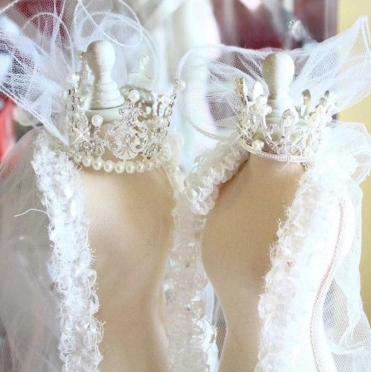 Close-up of a white lace garment on a mannequin with a blurred background