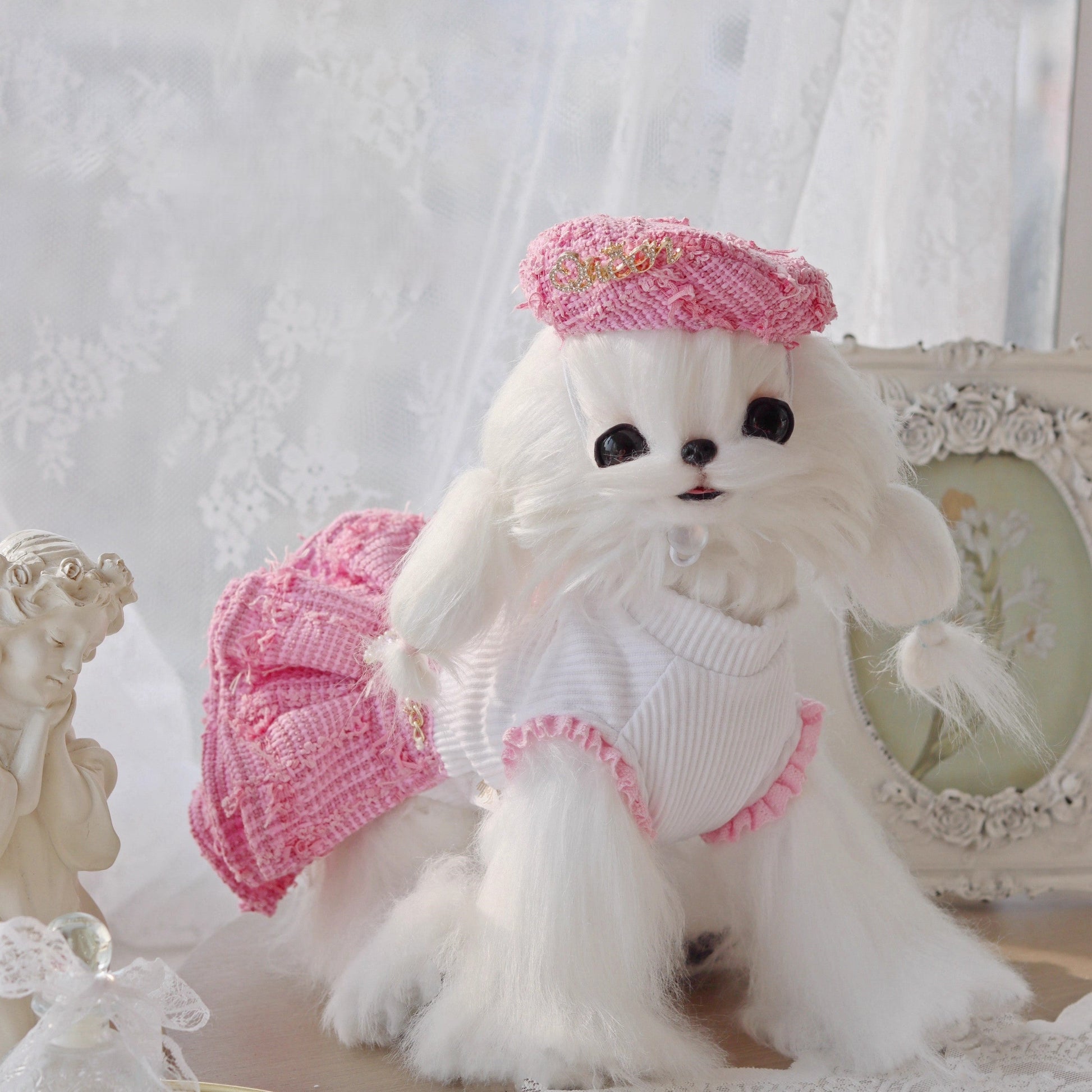 White fluffy dog toy with pink outfit and hat on a decorative background