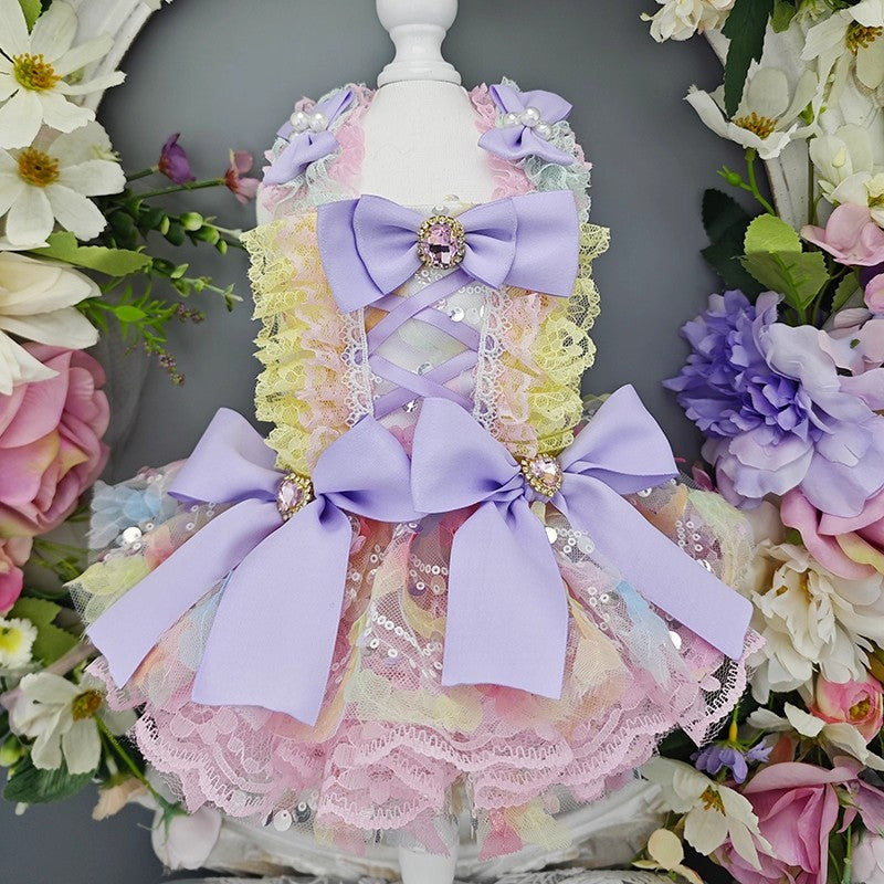 Pastel-colored dress with large bows on a mannequin surrounded by flowers