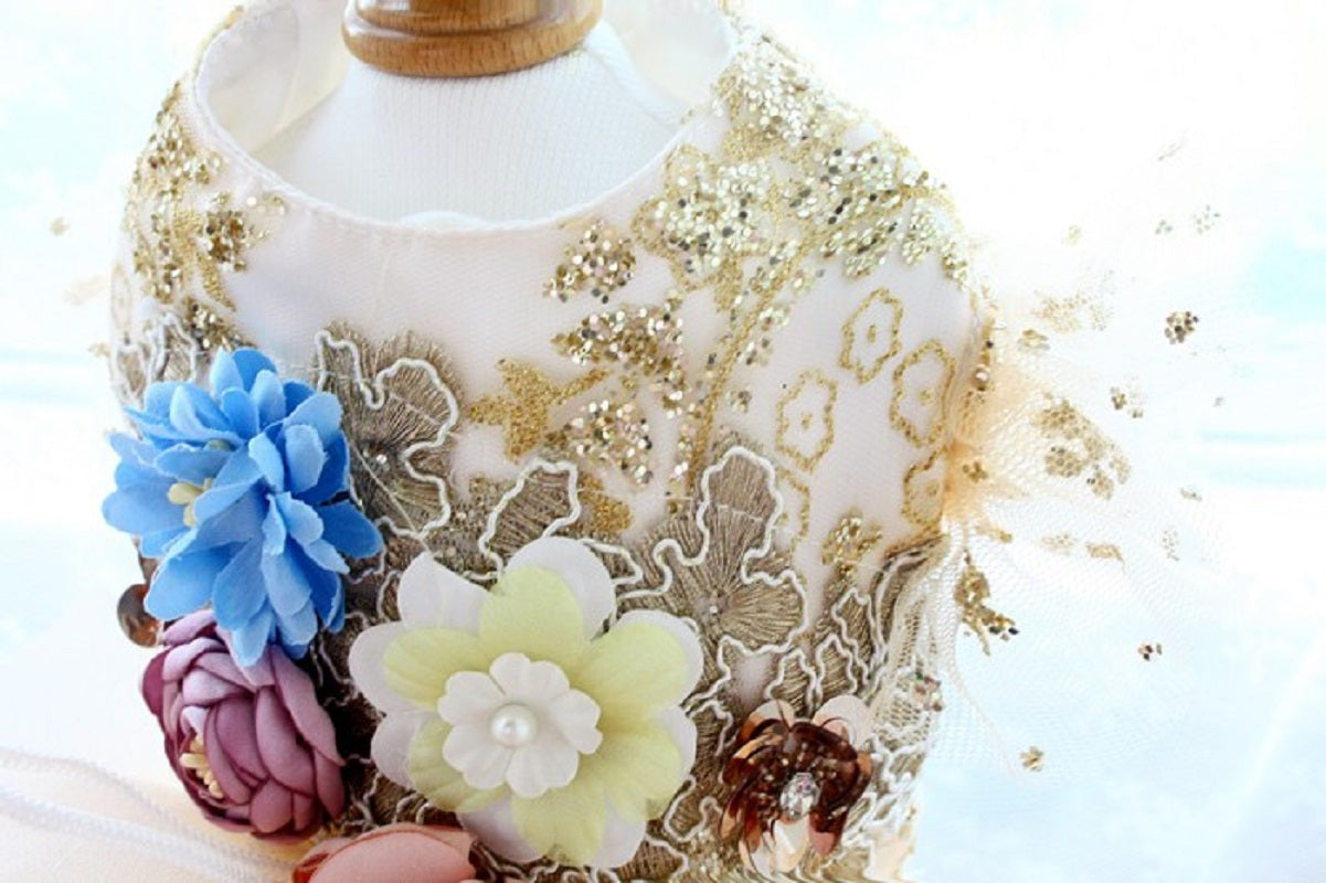 Decorative bottle with floral designs and gold accents on a light background