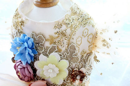 Decorative bottle with floral designs and gold accents on a light background