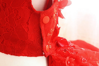 Red lace garment with buttons on a white background