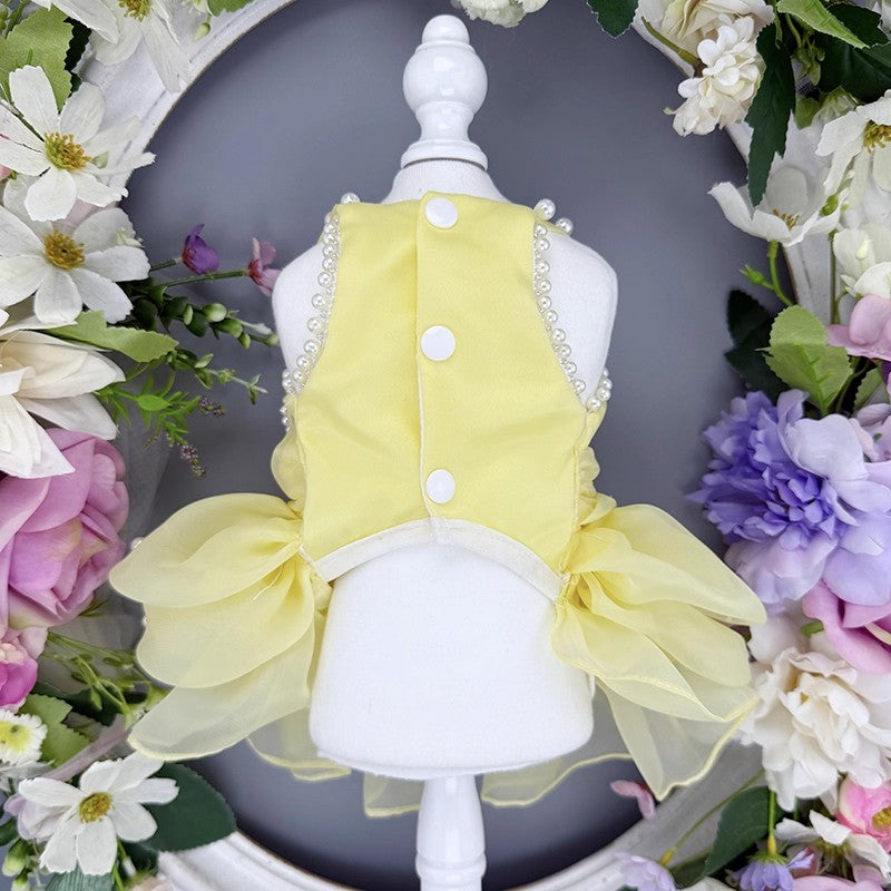 Yellow pet dress on a mannequin with floral decorations