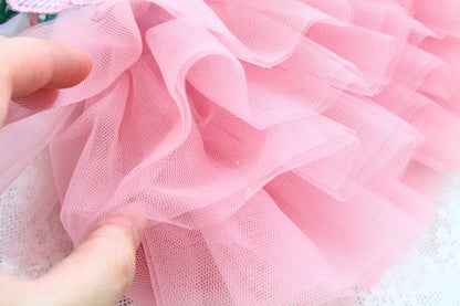 Close-up of pink tulle fabric held by a hand
