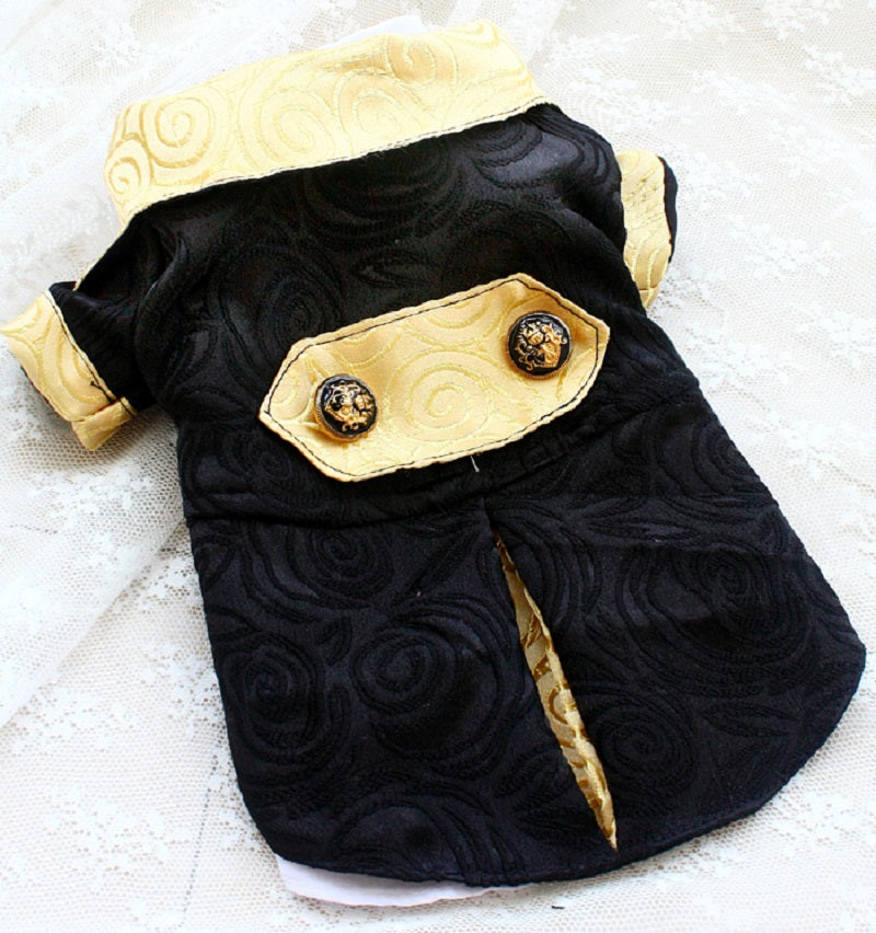 Black and gold dog costume on a textured white surface