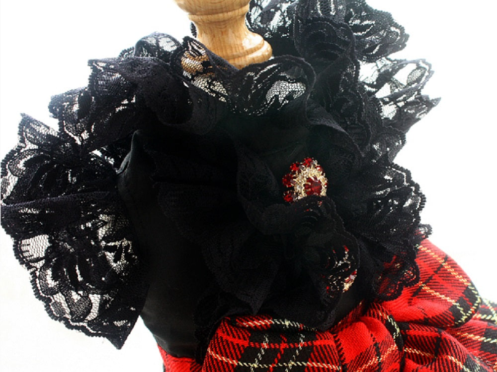 Black lace top with red plaid skirt on a white background