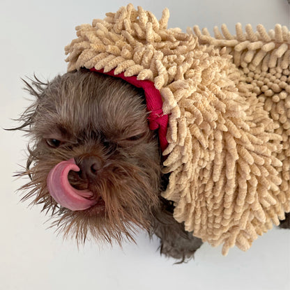 Dog wearing a beige fuzzy costume on a white background