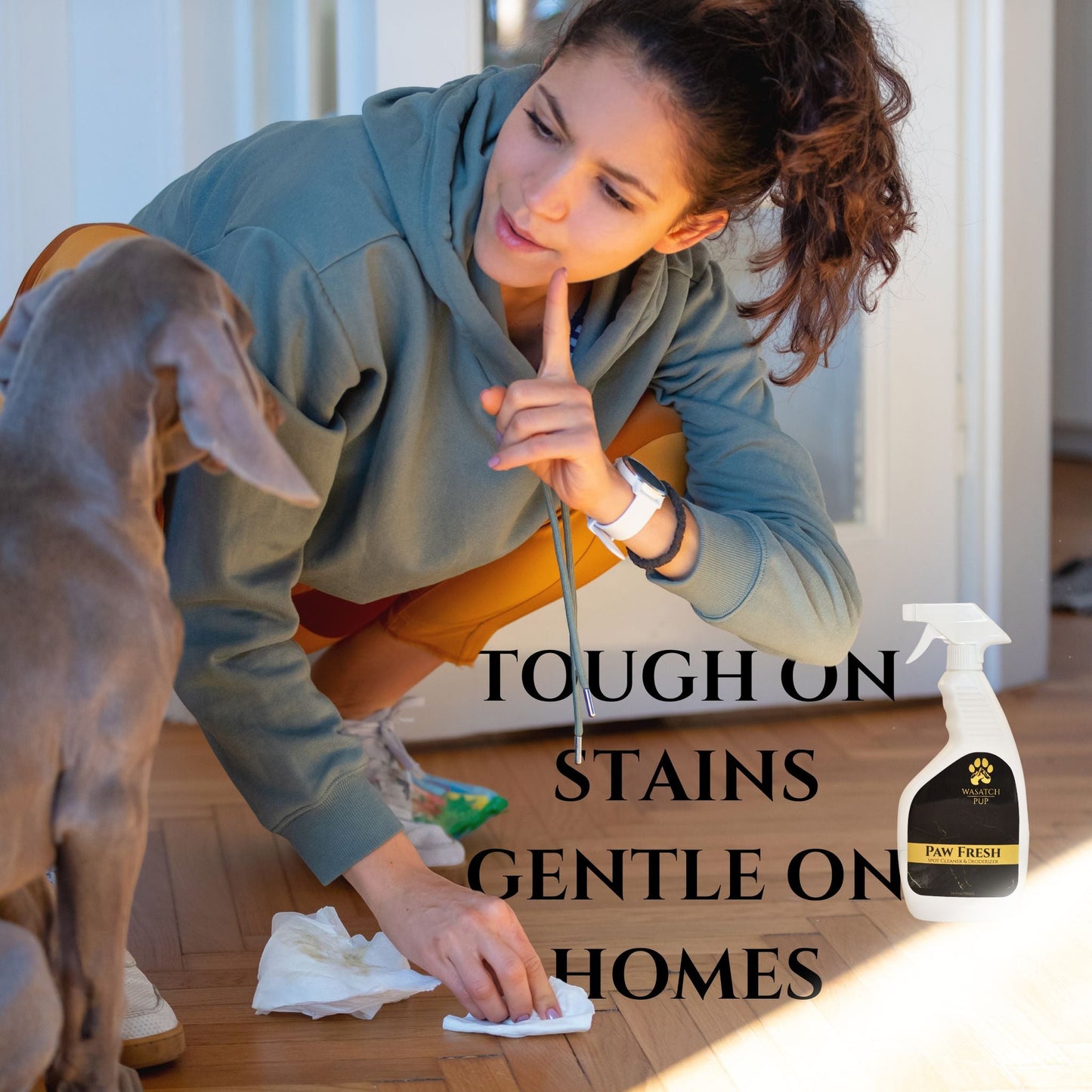 Woman cleaning a wooden floor with a dog, featuring a paw fresh spray bottle.