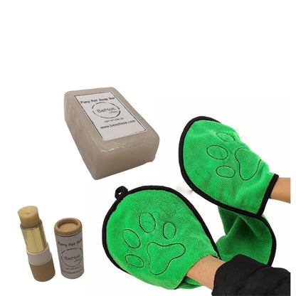 Green pet grooming mitts with paw design, soap bar, and two small containers on a white background.
