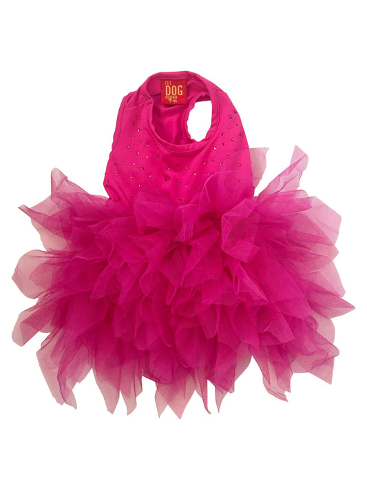 Pink pet dress with ruffled layers on a white background