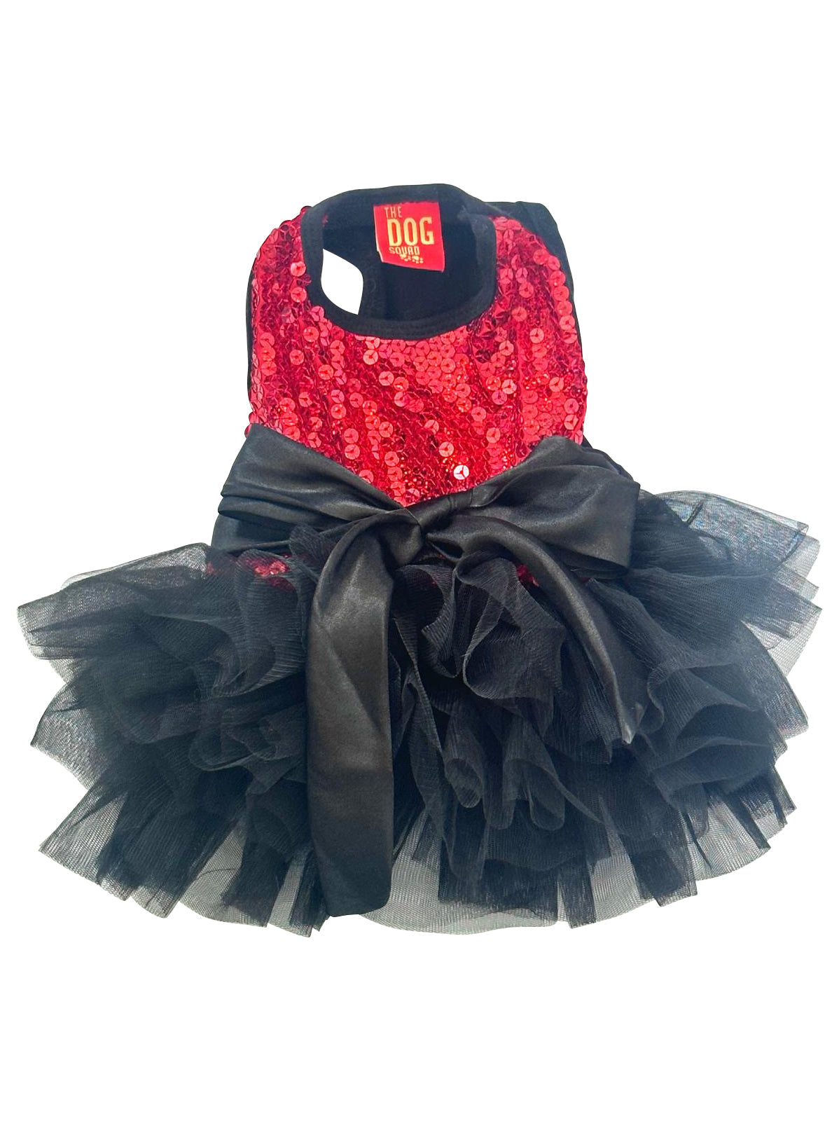 Dog harness with red sequin top and black tutu skirt on a white background