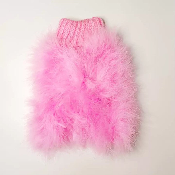 Pink fluffy dog sweater on a light gray background