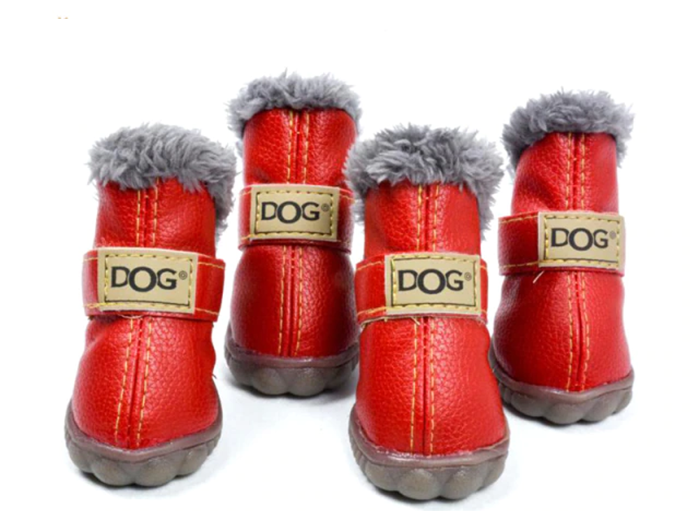 Set of red dog boots with gray fur on top and 'DOG' labels on a white background
