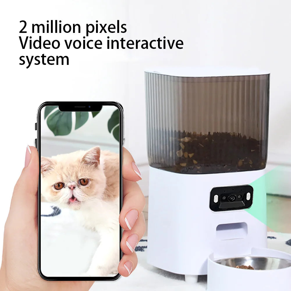 Pet feeder with smartphone displaying a cat's face, labeled '2 million pixels Video voice interactive system'.