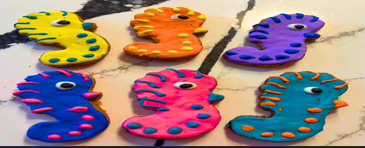 Colorful seahorse-shaped objects on a textured surface